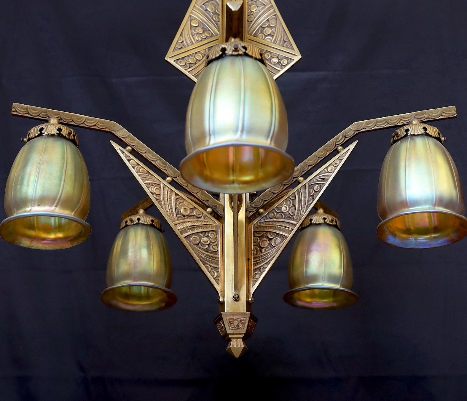 A French Art Deco Valinale de Sevres gilt bronze five light chandelier, of stylish geometric design with iridescent gold tinted glass shades, height 100cm. width 65cm